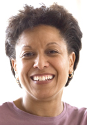 Middle-aged woman smiling for the camera at her desk