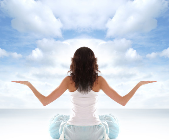 Young fit brunette meditating isolated on white