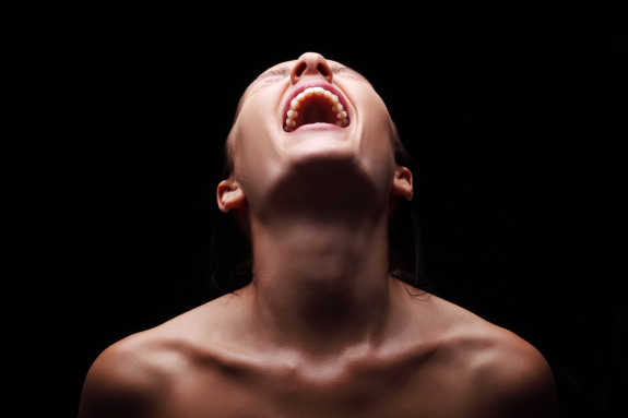 Screaming woman over black background