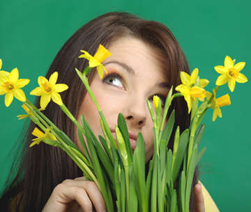 Beautiful  girl with yellow flowers. green background