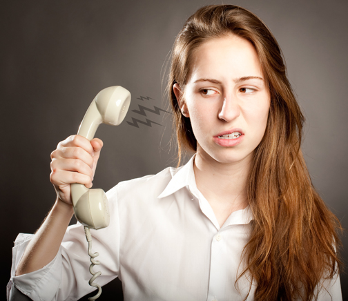 stressed young woman holding a telephone