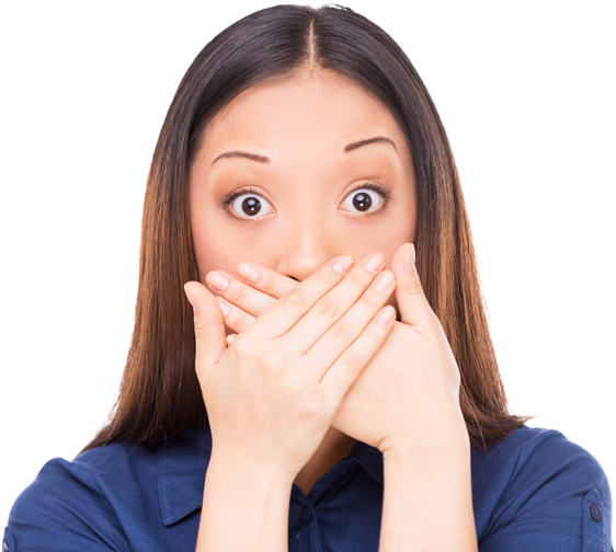 Surprised young Asian woman covering mouth with hands and staring at camera while standing isolated on white ** Note: Soft Focus at 100%, best at smaller sizes