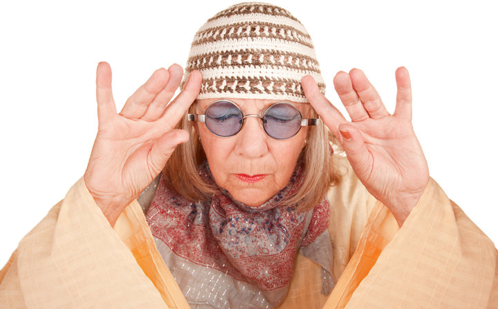 Crazy new age woman in a yellow robe concentrating or forming image